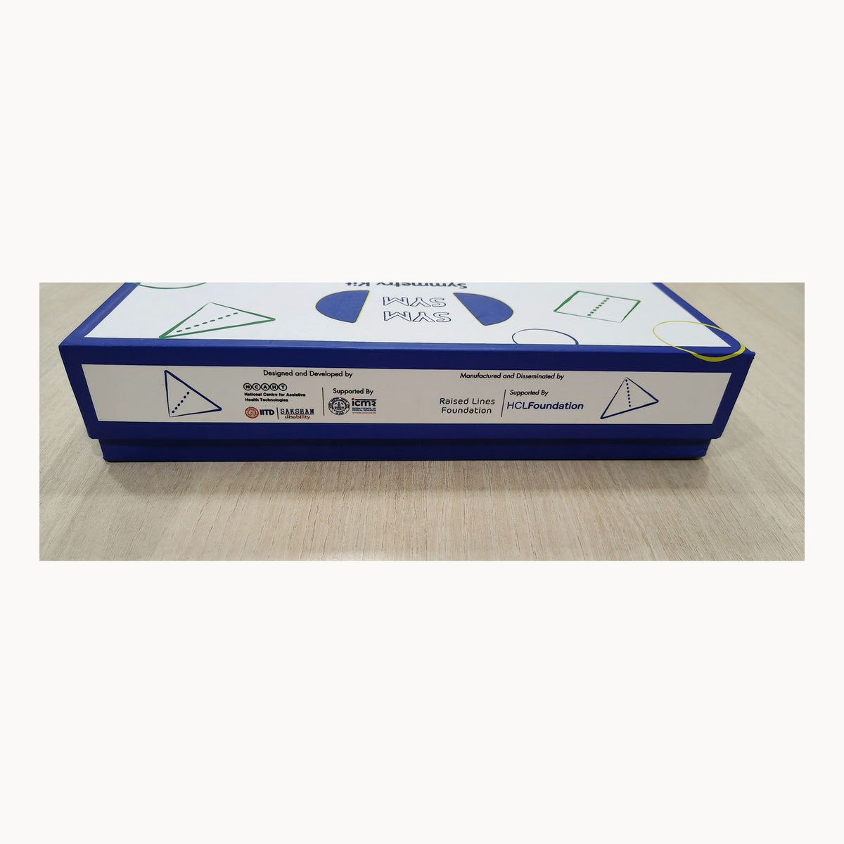 SymSym product box crediting NCAHT IIT Delhi and Saksham, Raised Lines Foundation, ICMR and HCL Foundation