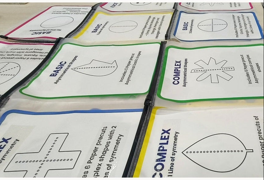 Close-up of pre-cut SymSym tactile shape packets showing examples of one, two and multiple lines of symmetry