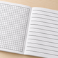 Illustrative classroom use of the Bold Lines Combo Pad combining graph work with large handwriting on facing pages
