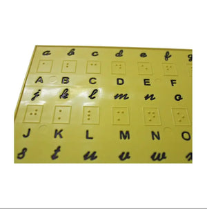 Close-up of Braille dots and print letters on English alphabet training plate