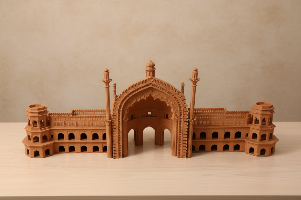 A miniature architectural model of a historic palace Rumi Darwaja with a central arch, displayed on a white tabletop.