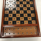Wooden checkers board with checkers on a white background