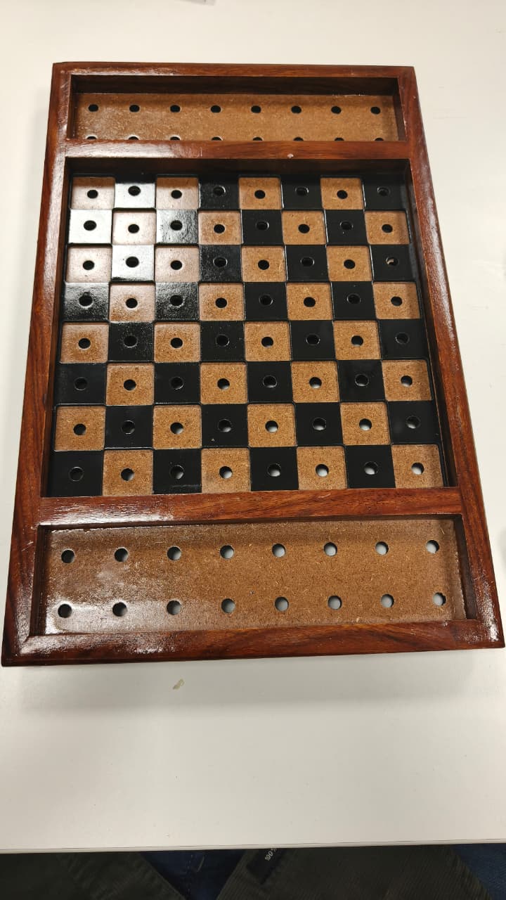 Wooden checkers board with checkers on a white background