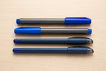 Four blue and black pens in the Bold Lines writing set: two Unomax Boldtron 2X writing pens and two Luxor Sign Pens